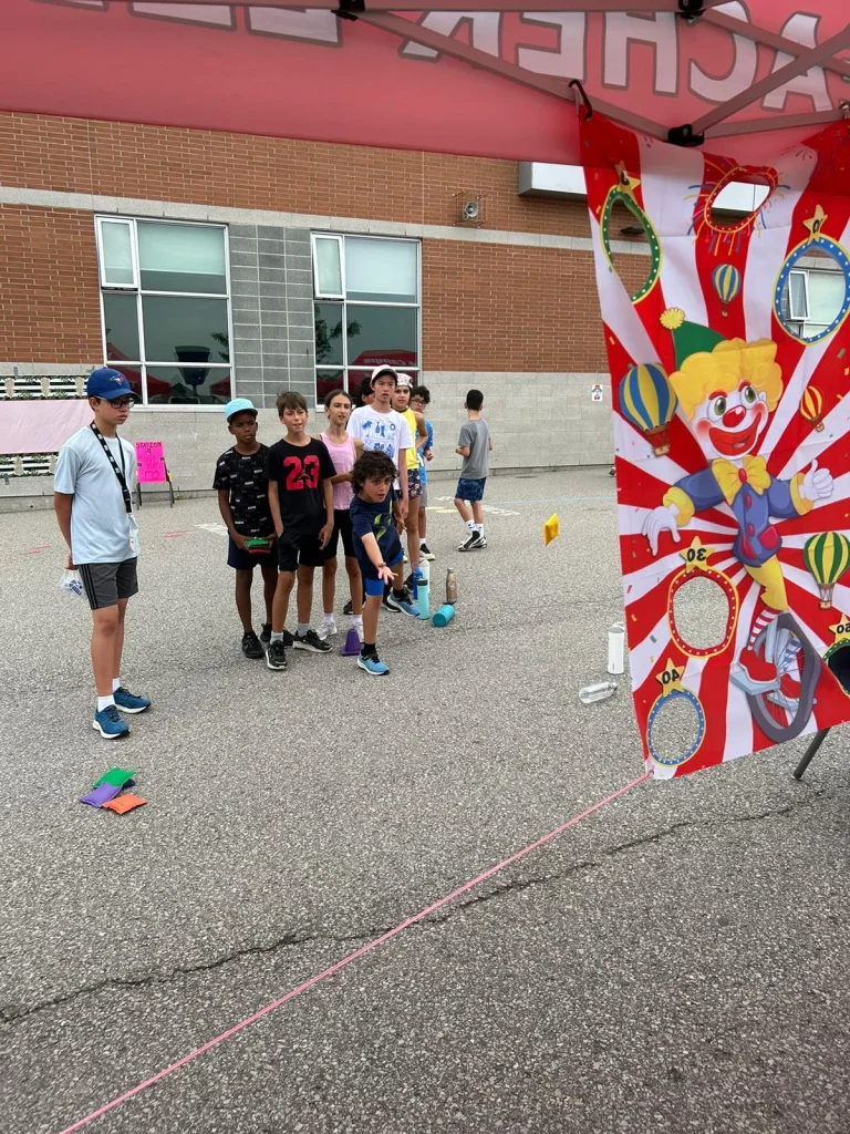 A group of campers looks on considering the next move at a Camp-Wide-Activity at Rouge Camps Richmond Hill.