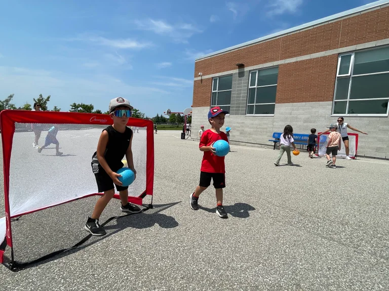Campers play euro handball outdoors at Rouge Camps Woodbridge.