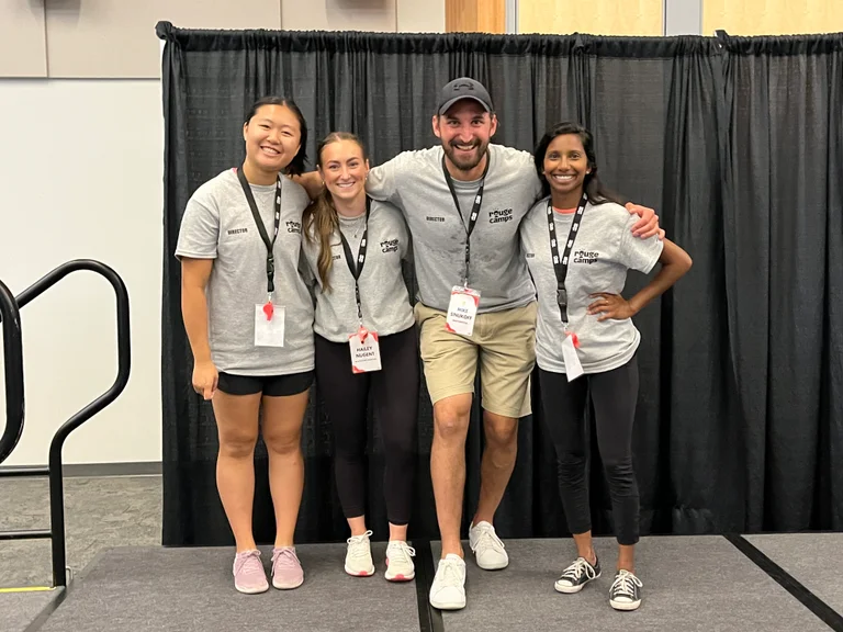 Physical education teachers make for ideal camp directors. In this photo three experienced physical education teachers pose with a staff member at the Rouge Camps Staff Training Conference. Physical education teachers know how to structure activities safely, are experts at connecting with youth and bringing them together in inclusive active environments.