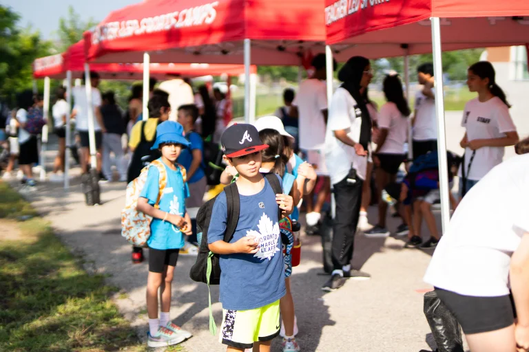 Kid standing near tents during drop off