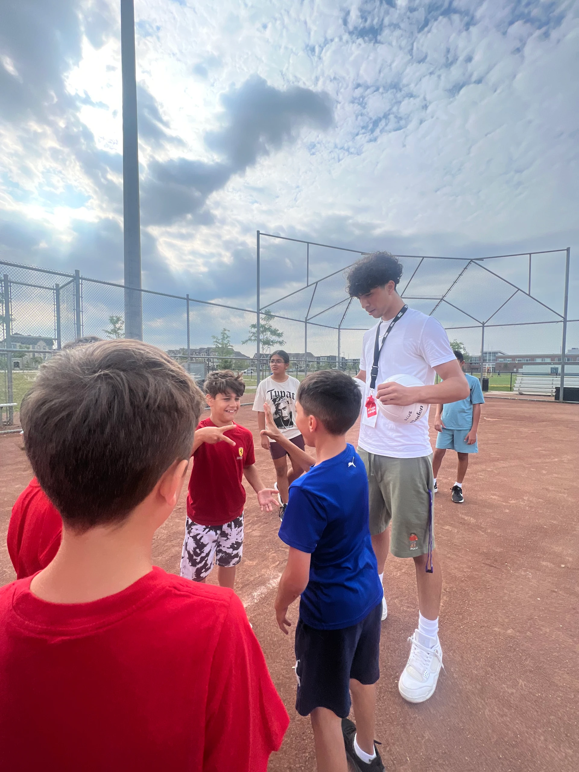Staff and campers hang out at a soccer baseball exploratory sport period at Rouge Camps Woodbridge.