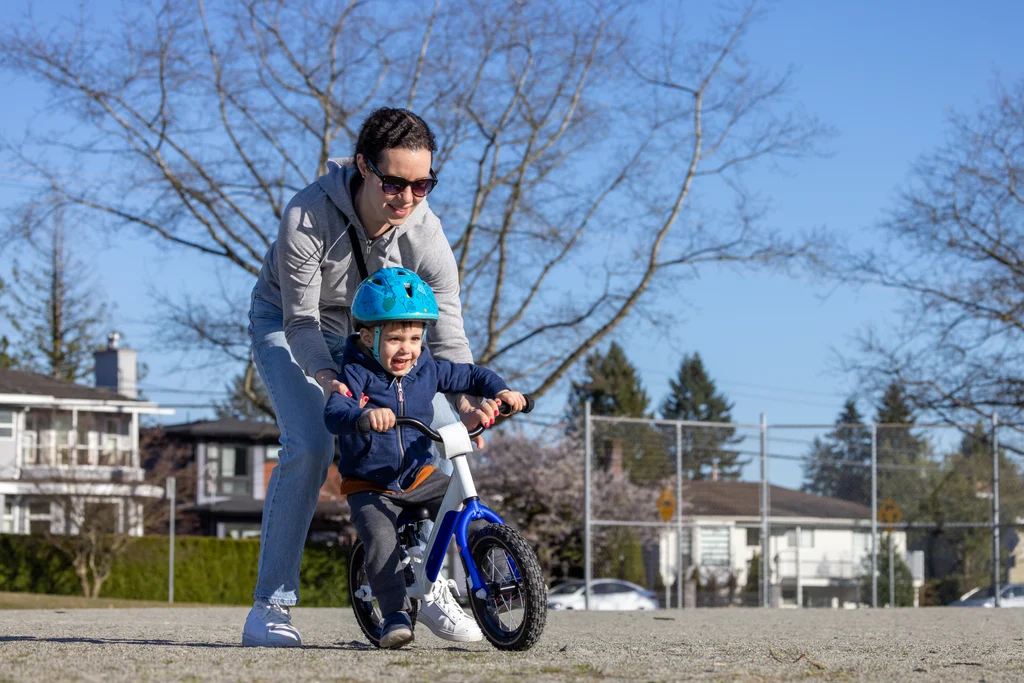 mother-teaching-young-child-to-ride-a-bike-outdoor-2026